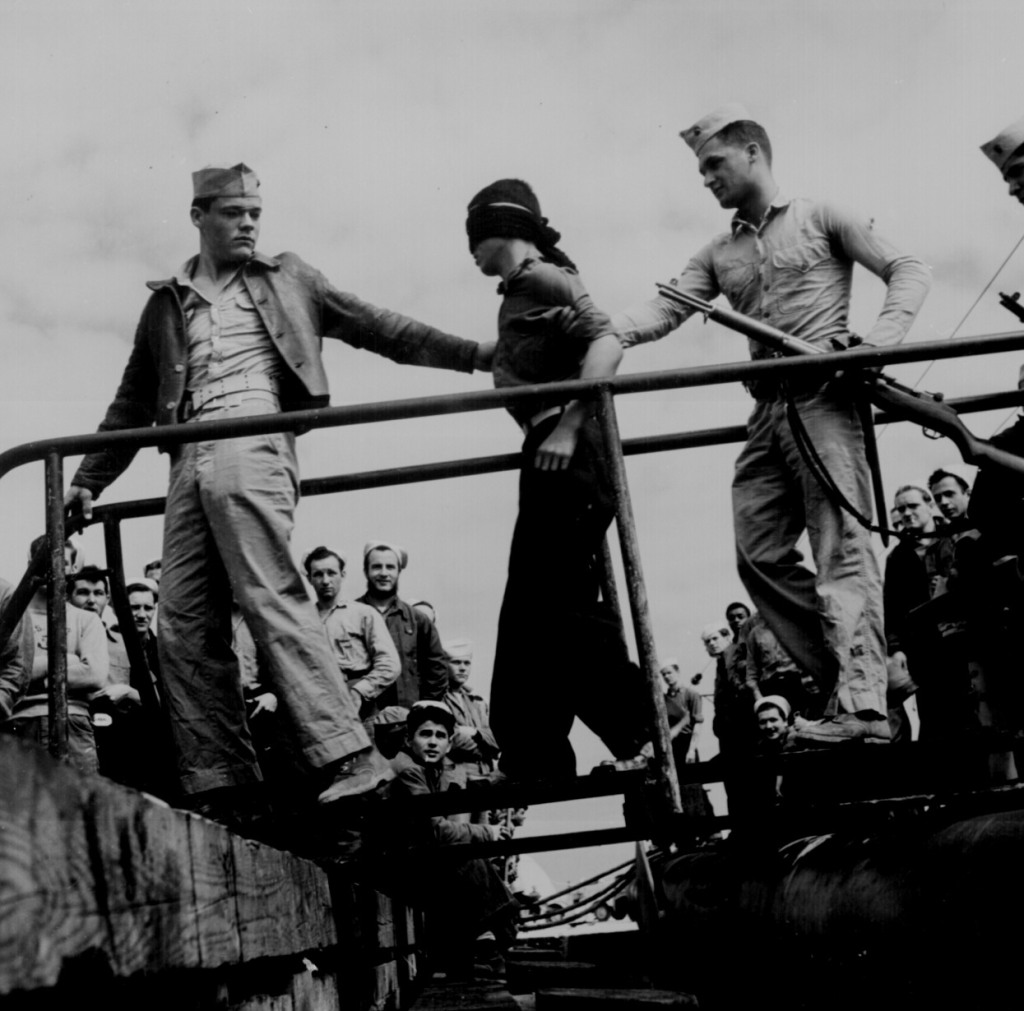 Marines unloading Japanese POW from a submarine returned from war patrol." Lt. Comdr. Horace Bristol, ca. May 1945.